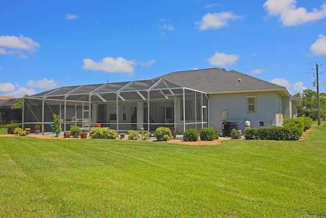 260 Rotonda Blvd E, Rotonda West, FL 33947 - rear view of property with stucco siding, a yard, and a lanai