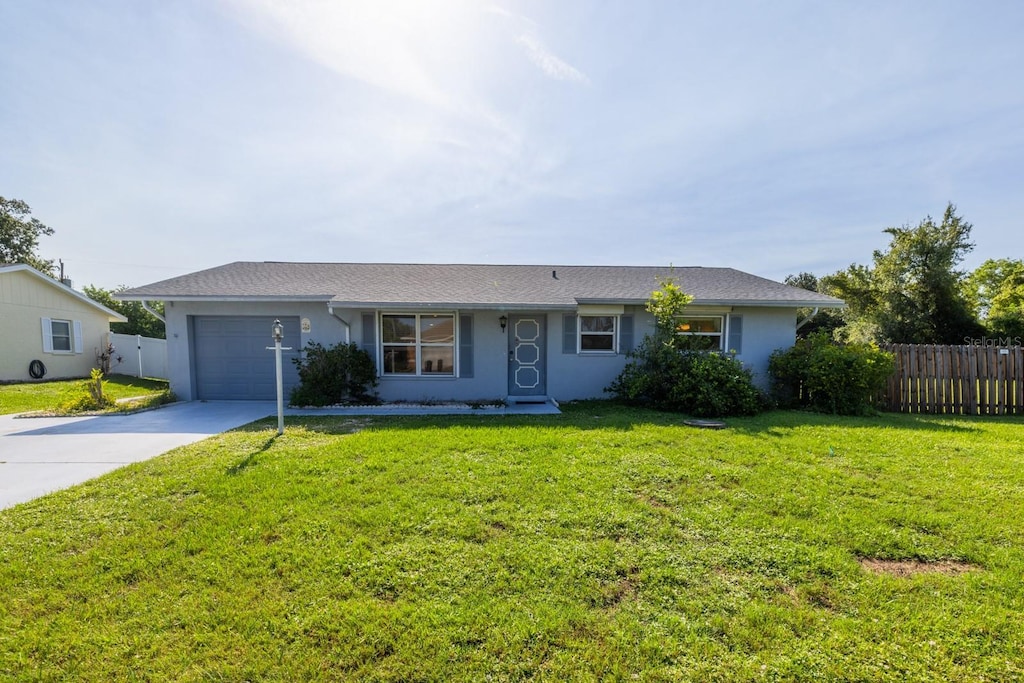 3270 Ithaca St, Port Charlotte, FL 33952 - single story home with a garage, driveway, and stucco siding
