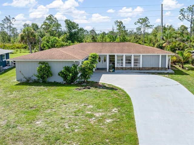 123 Annapolis Ln, Rotonda West, FL 33947 - single story home with concrete driveway, a front yard, and roof with shingles