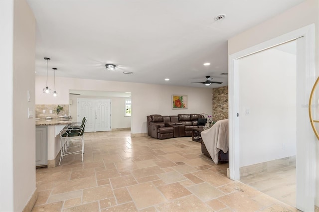 123 Annapolis Ln, Rotonda West, FL 33947 - living area with ceiling fan, recessed lighting, and light stone finish flooring