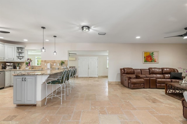 123 Annapolis Ln, Rotonda West, FL 33947 - kitchen with stainless steel dishwasher, a breakfast bar, a ceiling fan, recessed lighting, and open shelves