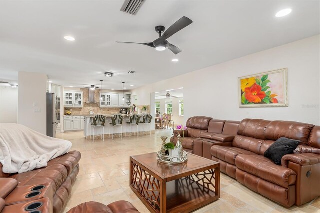 123 Annapolis Ln, Rotonda West, FL 33947 - living room with a ceiling fan, recessed lighting, and stone tile flooring