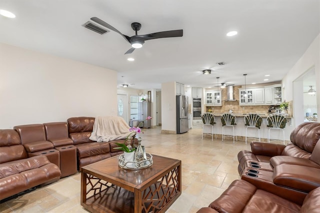 123 Annapolis Ln, Rotonda West, FL 33947 - living area featuring ceiling fan, stone tile flooring, and recessed lighting