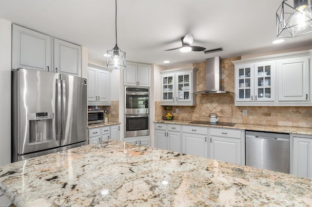 123 Annapolis Ln, Rotonda West, FL 33947 - kitchen with appliances with stainless steel finishes, wall chimney exhaust hood, decorative backsplash, glass insert cabinets, and white cabinets