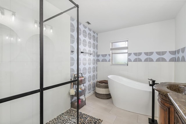 123 Annapolis Ln, Rotonda West, FL 33947 - full bath with a freestanding tub, vanity, a stall shower, tile walls, and tile patterned floors