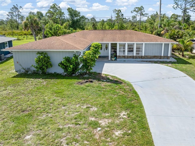 123 Annapolis Ln, Rotonda West, FL 33947 - single story home with concrete driveway, a front lawn, and roof with shingles