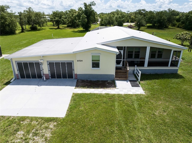 10724 SW Park Ave, Arcadia, FL 34269 - view of front of property featuring a sunroom, a front lawn, and concrete driveway