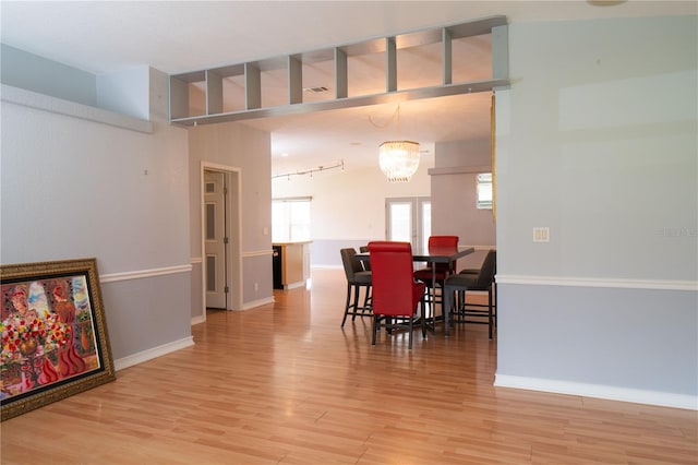 10724 SW Park Ave, Arcadia, FL 34269 - dining space with light wood-type flooring and a chandelier