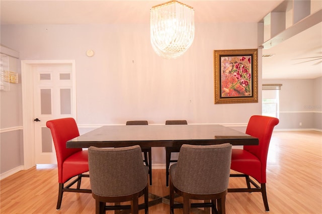 10724 SW Park Ave, Arcadia, FL 34269 - dining area with light wood-type flooring and a chandelier