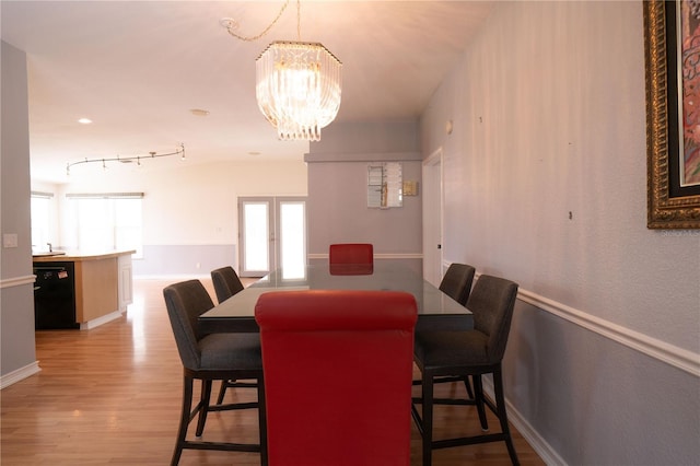 10724 SW Park Ave, Arcadia, FL 34269 - dining room featuring a chandelier and light wood-style floors