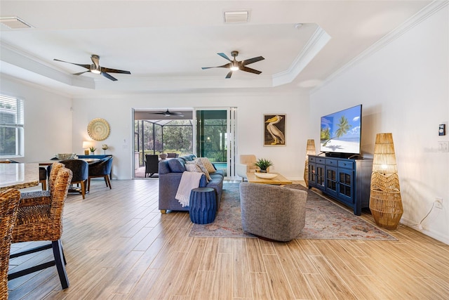 14684 Cherry Blossom Way, Punta Gorda, FL 33955 - living area featuring a raised ceiling, ceiling fan, healthy amount of natural light, and ornamental molding