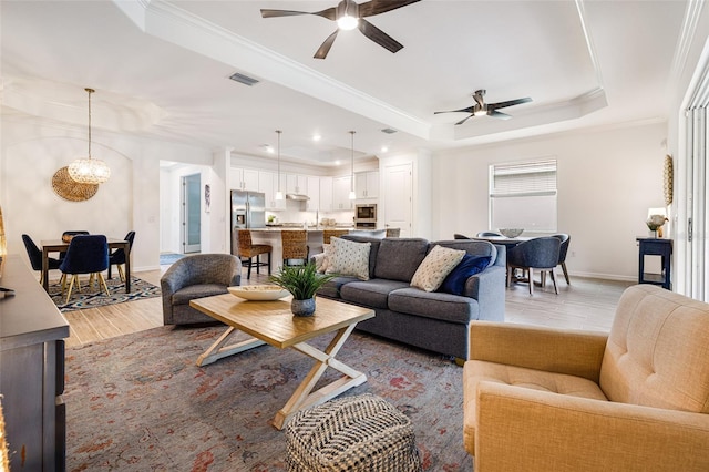 14684 Cherry Blossom Way, Punta Gorda, FL 33955 - living area featuring a raised ceiling, a ceiling fan, light wood-type flooring, recessed lighting, and crown molding