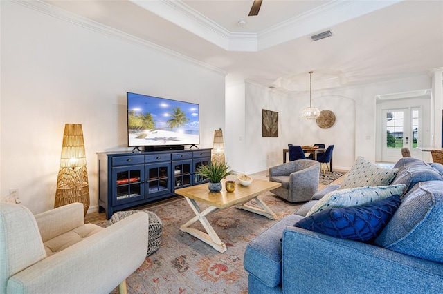 14684 Cherry Blossom Way, Punta Gorda, FL 33955 - living room featuring crown molding, a tray ceiling, wood finished floors, a ceiling fan, and a chandelier