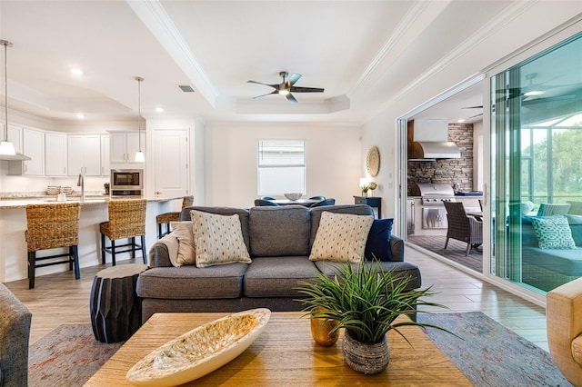 14684 Cherry Blossom Way, Punta Gorda, FL 33955 - living room with a ceiling fan, crown molding, light wood finished floors, a tray ceiling, and recessed lighting