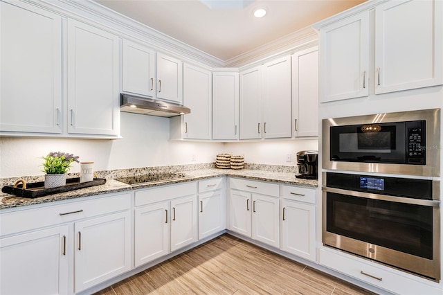 14684 Cherry Blossom Way, Punta Gorda, FL 33955 - kitchen featuring stainless steel oven, built in microwave, black electric cooktop, under cabinet range hood, and white cabinetry