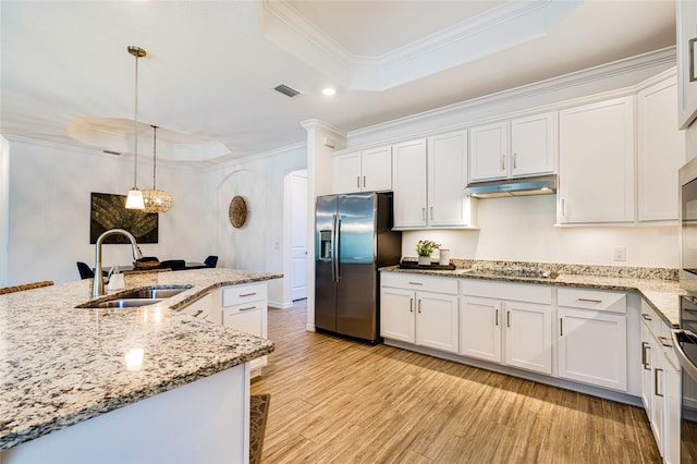 14684 Cherry Blossom Way, Punta Gorda, FL 33955 - kitchen featuring stainless steel fridge with ice dispenser, a raised ceiling, ornamental molding, under cabinet range hood, and light wood-type flooring