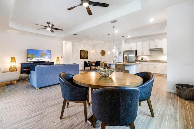 14684 Cherry Blossom Way, Punta Gorda, FL 33955 - dining space with a tray ceiling, ceiling fan, light wood-style floors, crown molding, and recessed lighting