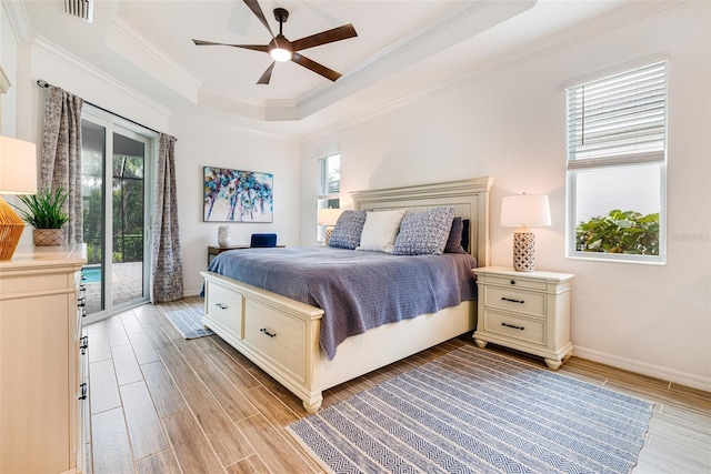 14684 Cherry Blossom Way, Punta Gorda, FL 33955 - bedroom with access to outside, light wood-type flooring, crown molding, a raised ceiling, and a ceiling fan
