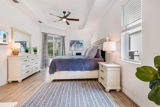 14684 Cherry Blossom Way, Punta Gorda, FL 33955 - bedroom featuring light wood-style floors, a tray ceiling, access to exterior, ornamental molding, and a ceiling fan