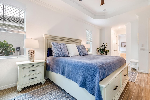 14684 Cherry Blossom Way, Punta Gorda, FL 33955 - bedroom featuring dark wood finished floors, ensuite bath, ceiling fan, and crown molding