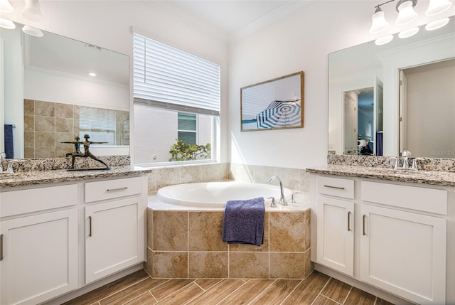 14684 Cherry Blossom Way, Punta Gorda, FL 33955 - bathroom with two vanities, a bath, ornamental molding, and wood finish floors