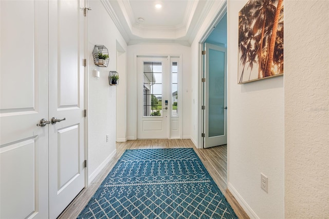 14684 Cherry Blossom Way, Punta Gorda, FL 33955 - doorway to outside with wood finished floors, ornamental molding, and a tray ceiling