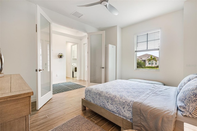 14684 Cherry Blossom Way, Punta Gorda, FL 33955 - bedroom with french doors, light wood-style floors, washer / dryer, and a ceiling fan