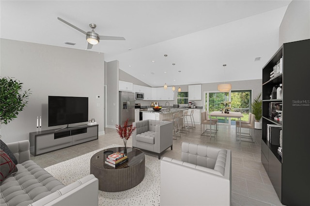 4863 Las Almanos Ave, North Port, FL 34288 - living room featuring vaulted ceiling, ceiling fan, and light tile patterned flooring