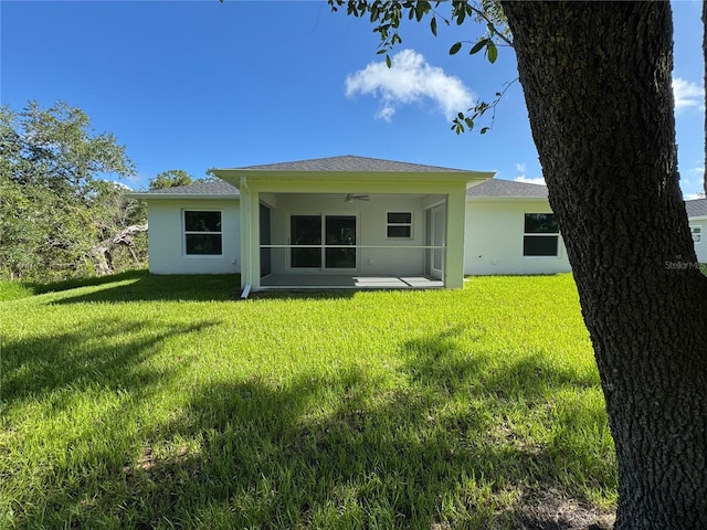 4863 Las Almanos Ave, North Port, FL 34288 - rear view of property with ceiling fan, stucco siding, a lawn, and a patio area
