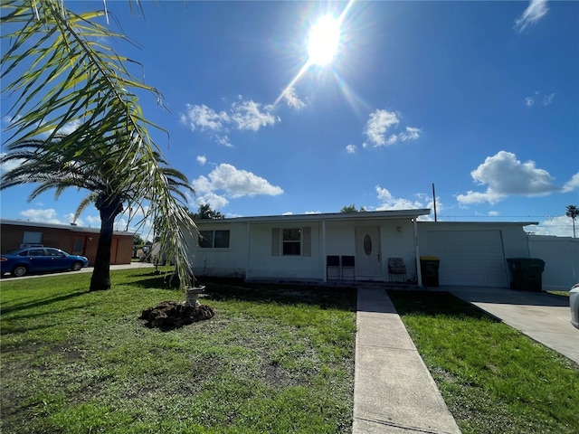2336 Picnic St, Port Charlotte, FL 33952 - view of front of house with an attached garage, a front lawn, and concrete driveway