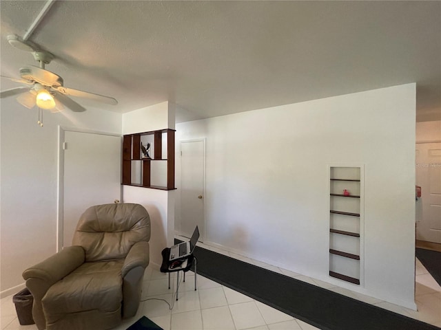 2336 Picnic St, Port Charlotte, FL 33952 - living area featuring a ceiling fan, tile patterned flooring, built in shelves, and a textured ceiling