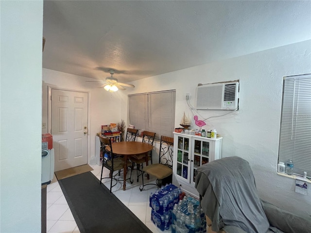 2336 Picnic St, Port Charlotte, FL 33952 - dining area with an AC wall unit, ceiling fan, light tile patterned flooring, a textured wall, and a textured ceiling