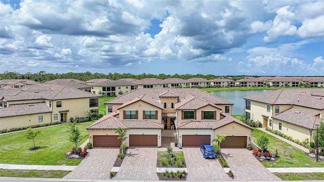 12425 Ghiberti Cir Unit 101, Venice, FL 34293 - view of front of house featuring a residential view, a tile roof, driveway, and a front yard