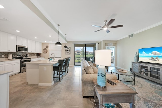 12425 Ghiberti Cir Unit 101, Venice, FL 34293 - living room with ornamental molding, a ceiling fan, recessed lighting, and light tile patterned flooring