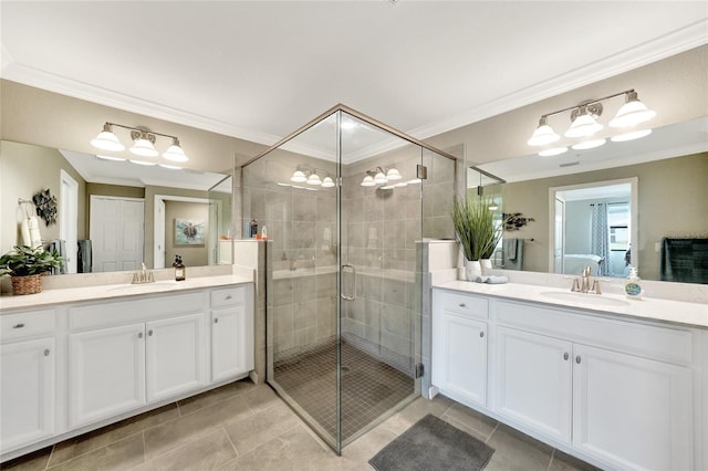 12425 Ghiberti Cir Unit 101, Venice, FL 34293 - bathroom featuring two vanities, a stall shower, tile patterned flooring, and ornamental molding