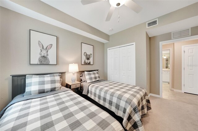 12425 Ghiberti Cir Unit 101, Venice, FL 34293 - bedroom featuring light carpet, a closet, and a ceiling fan