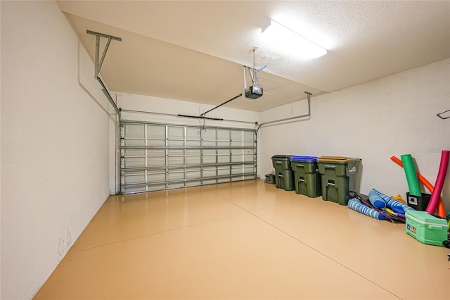 12425 Ghiberti Cir Unit 101, Venice, FL 34293 - garage featuring a garage door opener and concrete block wall