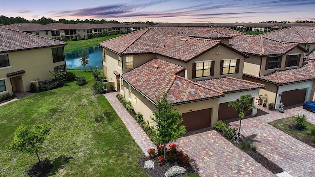 12425 Ghiberti Cir Unit 101, Venice, FL 34293 - view of front of home featuring stucco siding, a residential view, decorative driveway, and a tile roof