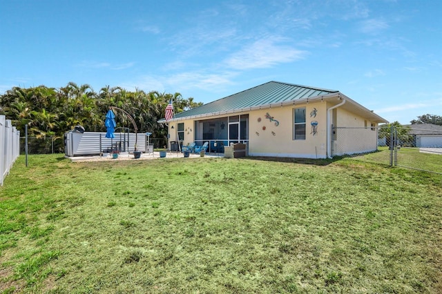 3116 SW 16th Pl, Cape Coral, FL 33914 - back of property with a sunroom, a standing seam roof, a fenced backyard, a metal roof, and stucco siding