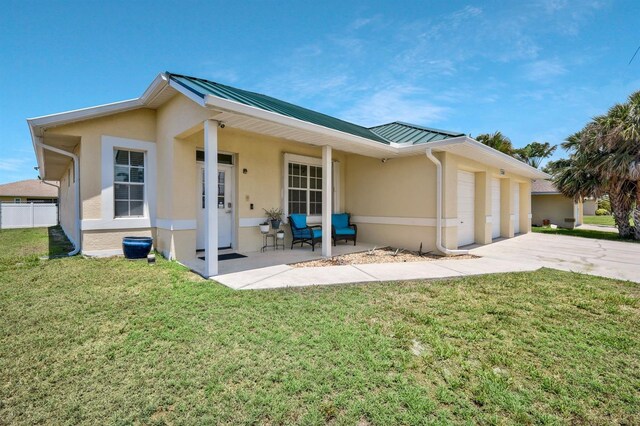 3116 SW 16th Pl, Cape Coral, FL 33914 - rear view of house featuring stucco siding, a standing seam roof, an attached garage, a metal roof, and concrete driveway