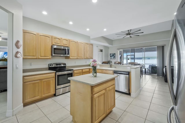 3116 SW 16th Pl, Cape Coral, FL 33914 - kitchen with appliances with stainless steel finishes, a peninsula, a ceiling fan, light countertops, and light brown cabinets