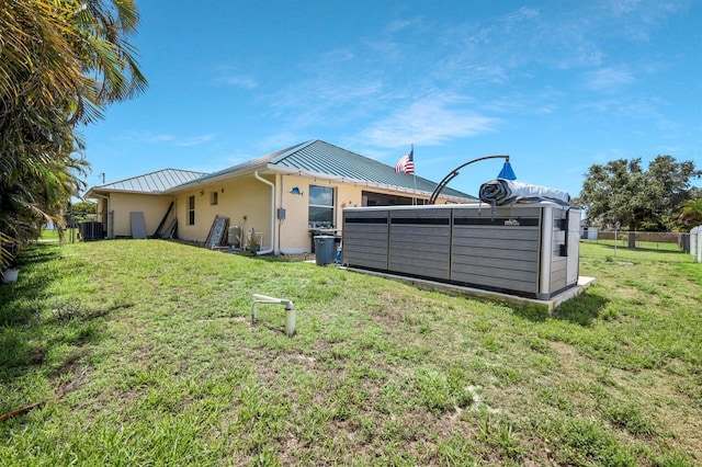 3116 SW 16th Pl, Cape Coral, FL 33914 - rear view of house featuring a standing seam roof, a metal roof, and stucco siding