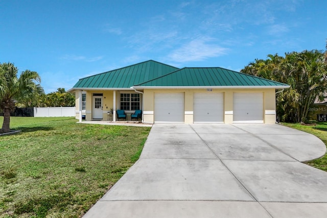 3116 SW 16th Pl, Cape Coral, FL 33914 - view of front of house featuring a standing seam roof, stucco siding, a garage, driveway, and a metal roof