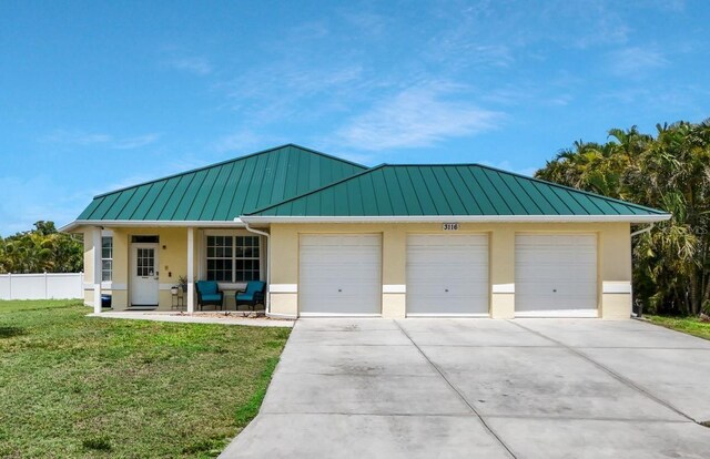 3116 SW 16th Pl, Cape Coral, FL 33914 - view of front of home with a standing seam roof, stucco siding, and a metal roof