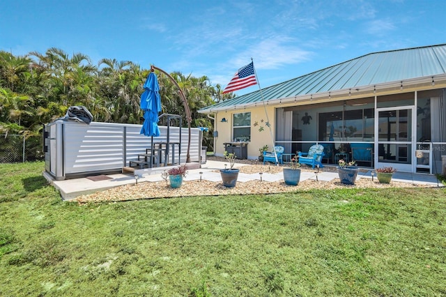 3116 SW 16th Pl, Cape Coral, FL 33914 - back of house with a standing seam roof, a sunroom, a metal roof, and stucco siding