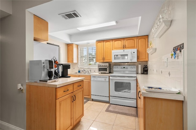 311 Garvin St Unit 301B, Punta Gorda, FL 33950 - kitchen with white appliances, tasteful backsplash, a tray ceiling, and light countertops