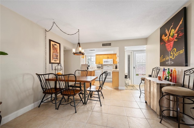 311 Garvin St Unit 301B, Punta Gorda, FL 33950 - dining room with light tile patterned flooring and a chandelier