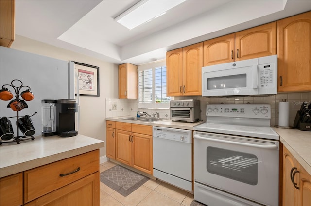 311 Garvin St Unit 301B, Punta Gorda, FL 33950 - kitchen featuring white appliances, backsplash, light countertops, light tile patterned floors, and a tray ceiling