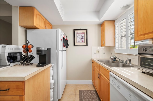311 Garvin St Unit 301B, Punta Gorda, FL 33950 - kitchen with white appliances, decorative backsplash, light countertops, a raised ceiling, and light tile patterned floors