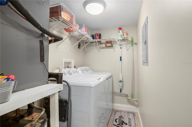 311 Garvin St Unit 301B, Punta Gorda, FL 33950 - laundry room featuring washing machine and clothes dryer, electric panel, and a textured ceiling